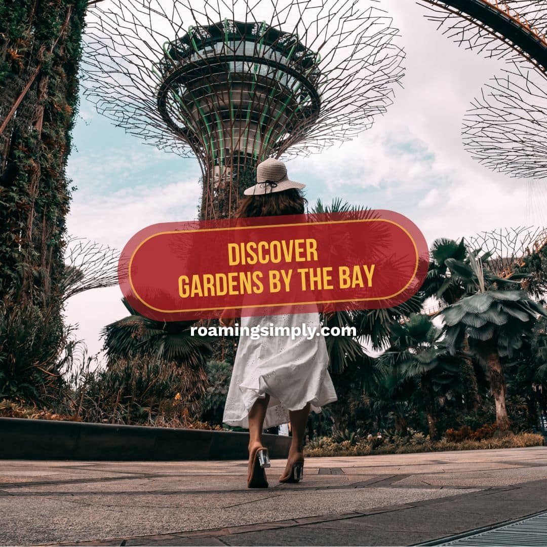 A woman in a white dress walking toward the iconic Supertree Grove at Gardens by the Bay in Singapore, featuring text that reads "Discover Gardens by the Bay."