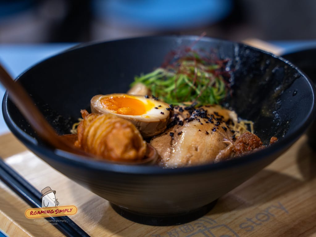 Close-up of Singapore-style ramen with chashu and tamago, RoamingSimply educational food content.