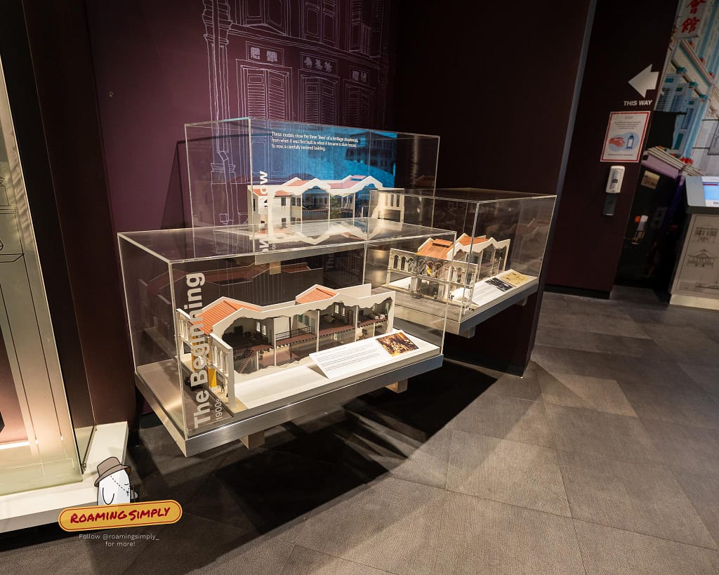 Close-up photograph of three detailed cross-section scale models in acrylic display cases at the Singapore City Gallery, illustrating the architectural evolution and restoration of a traditional heritage shophouse.