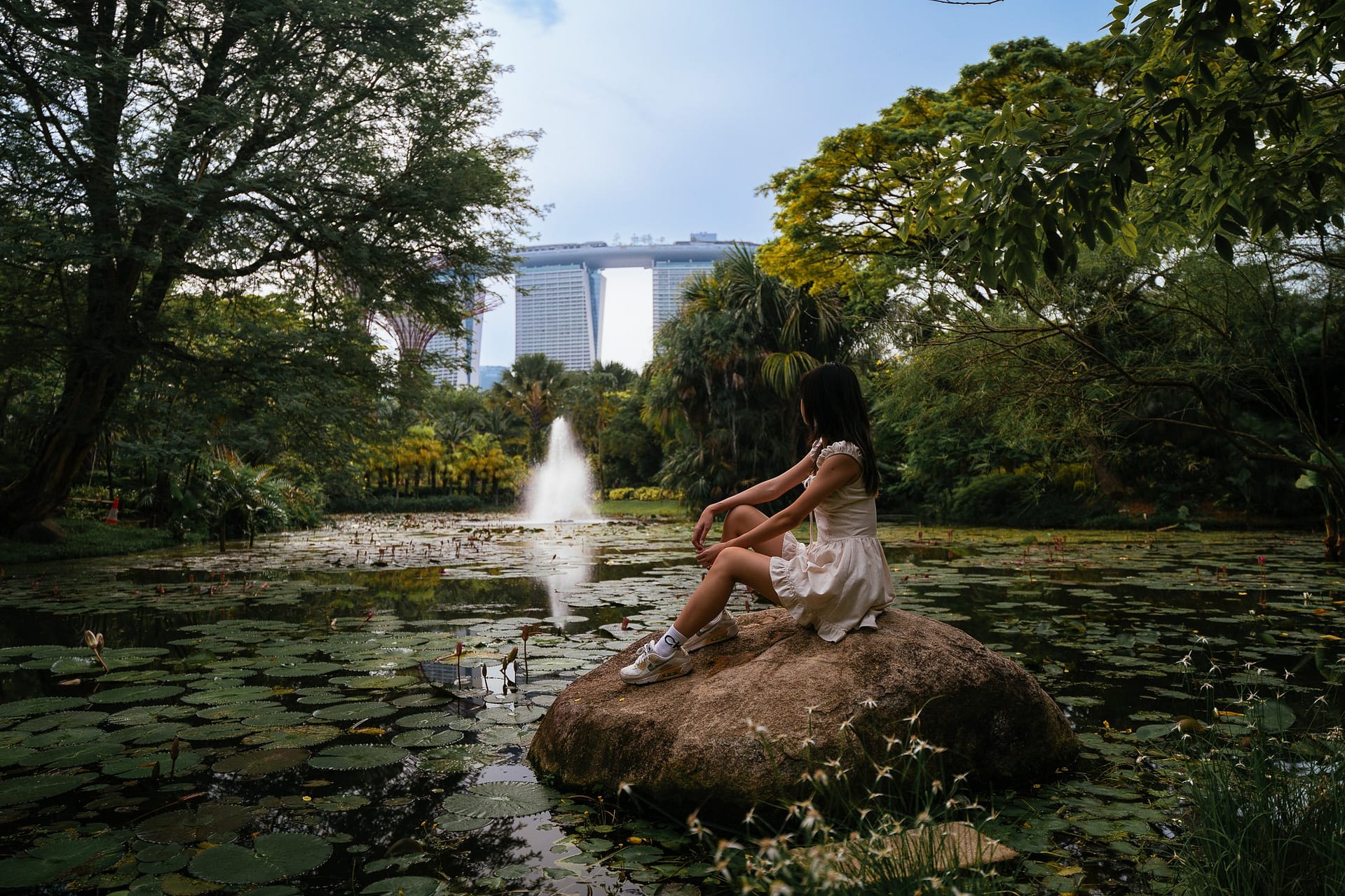 Girl at gardens by the bay with marina bay sands at the backgroud